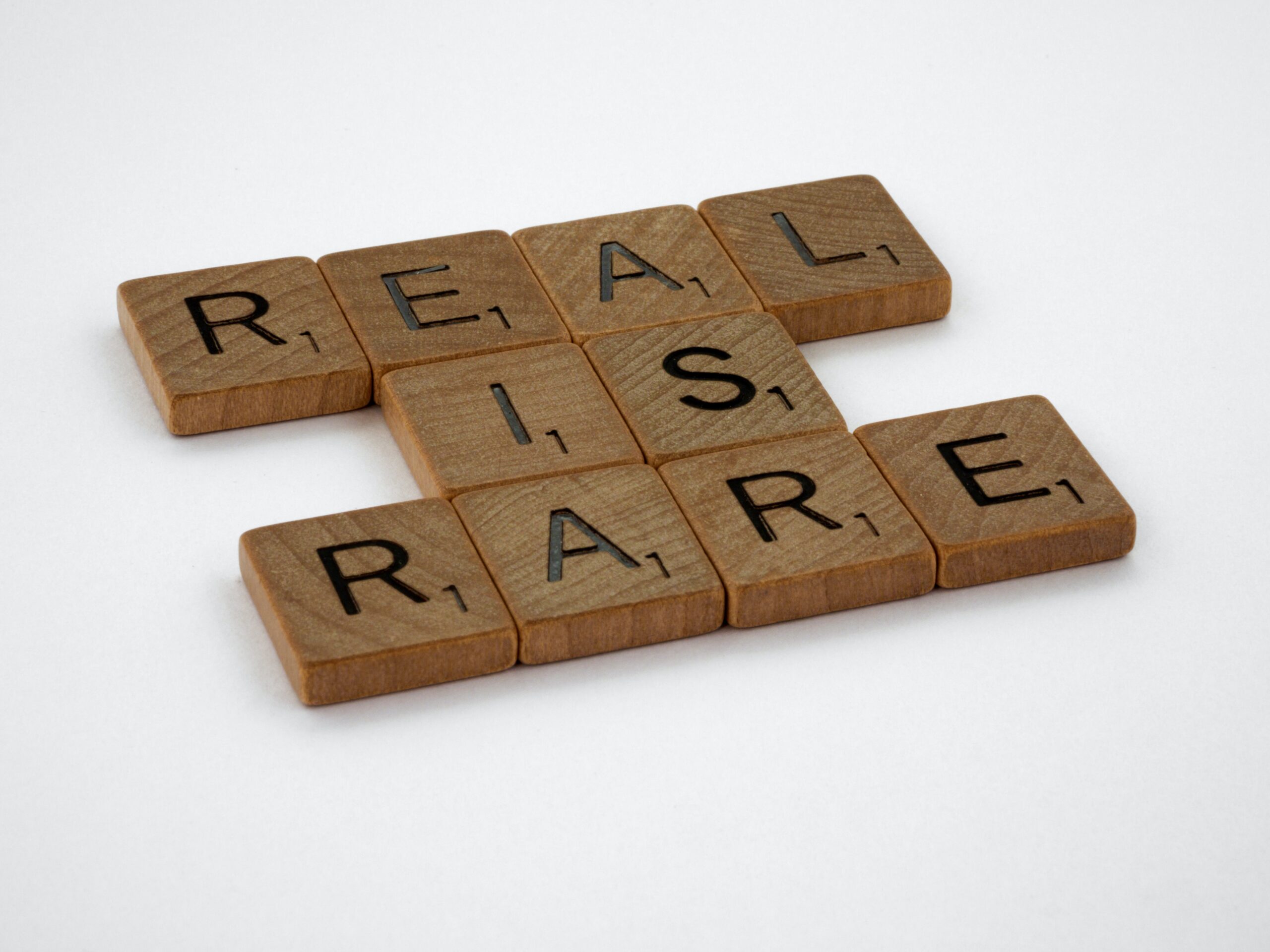 Scrabble tiles spells out "real is rare"
